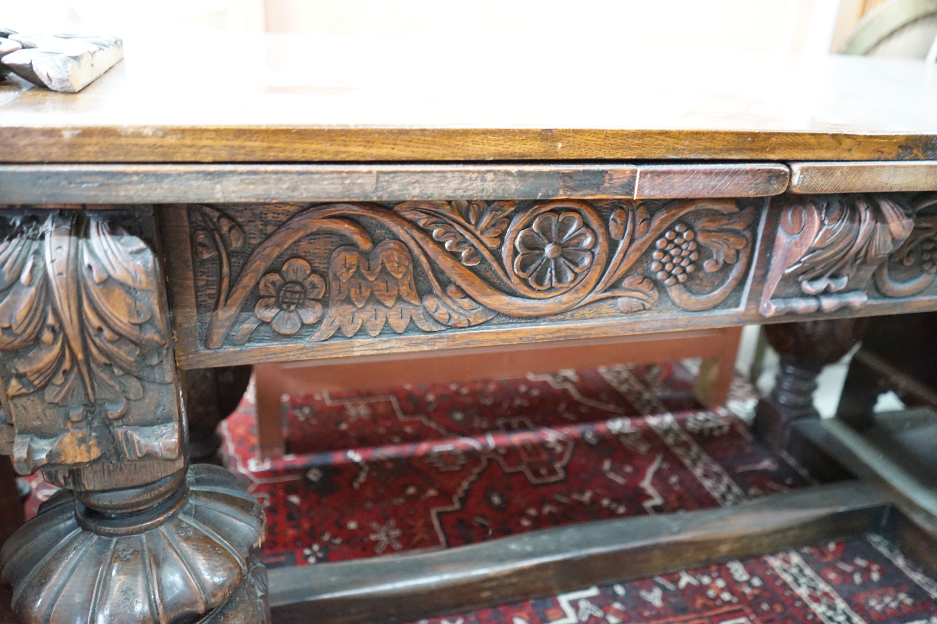 A 17th century style rectangular oak draw leaf dining table on carved baluster legs, 275cm extended, width 76cm, height 77cm